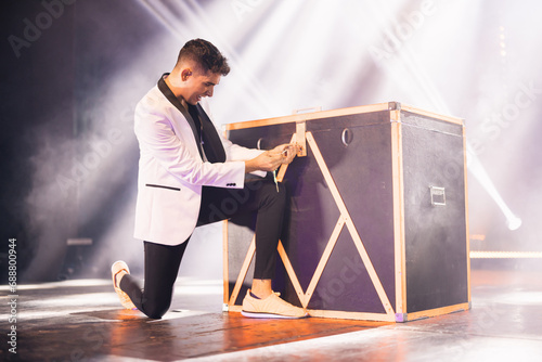 Magician locking box on stage during performance photo