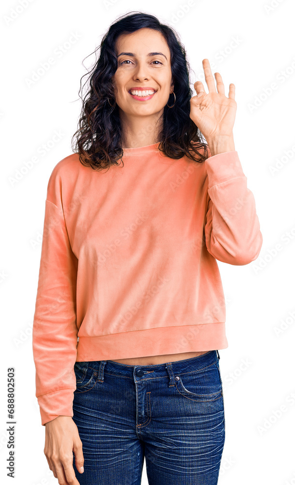 Young beautiful hispanic woman wearing casual clothes smiling positive doing ok sign with hand and fingers. successful expression. Young beautiful hispanic woman wearing casual clothes smiling positive doing ok sign with hand and fingers. successful expression.
