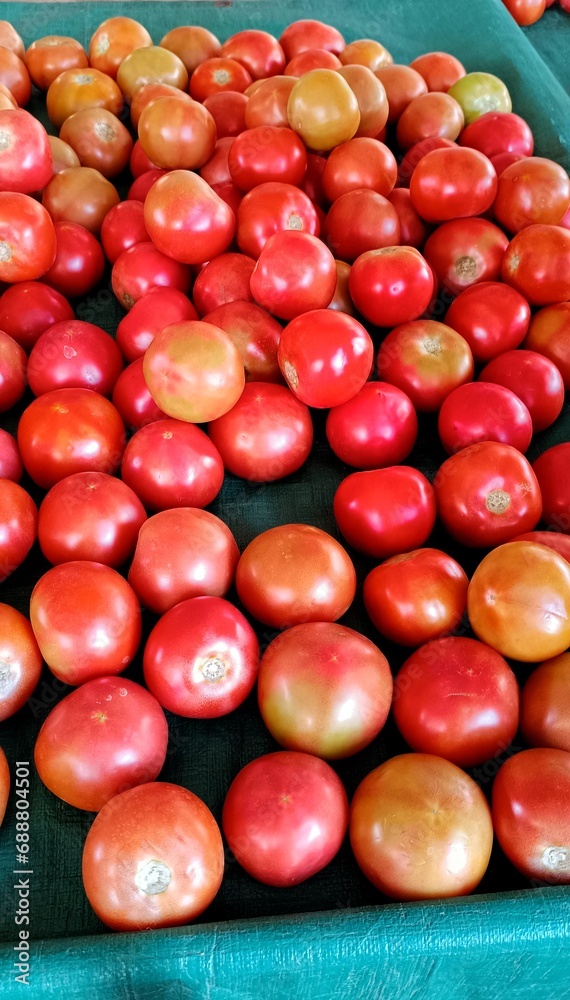 Close-up of tomatoes stacked for market sale Close-up of tomatoes stacked for market sale