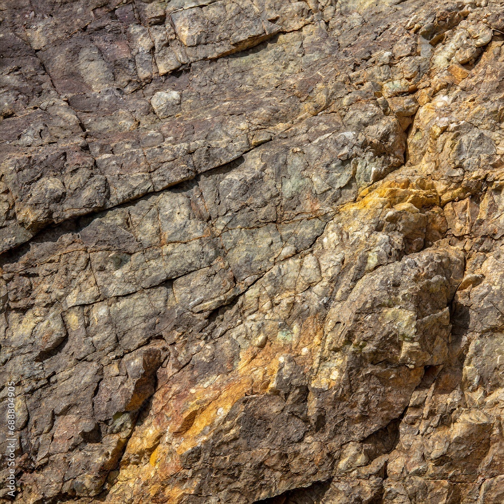 Granite background for design. Rough cracked mountain surface
