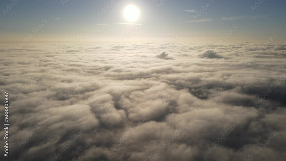 Aerial shot of the sunrise above a layer of clouds