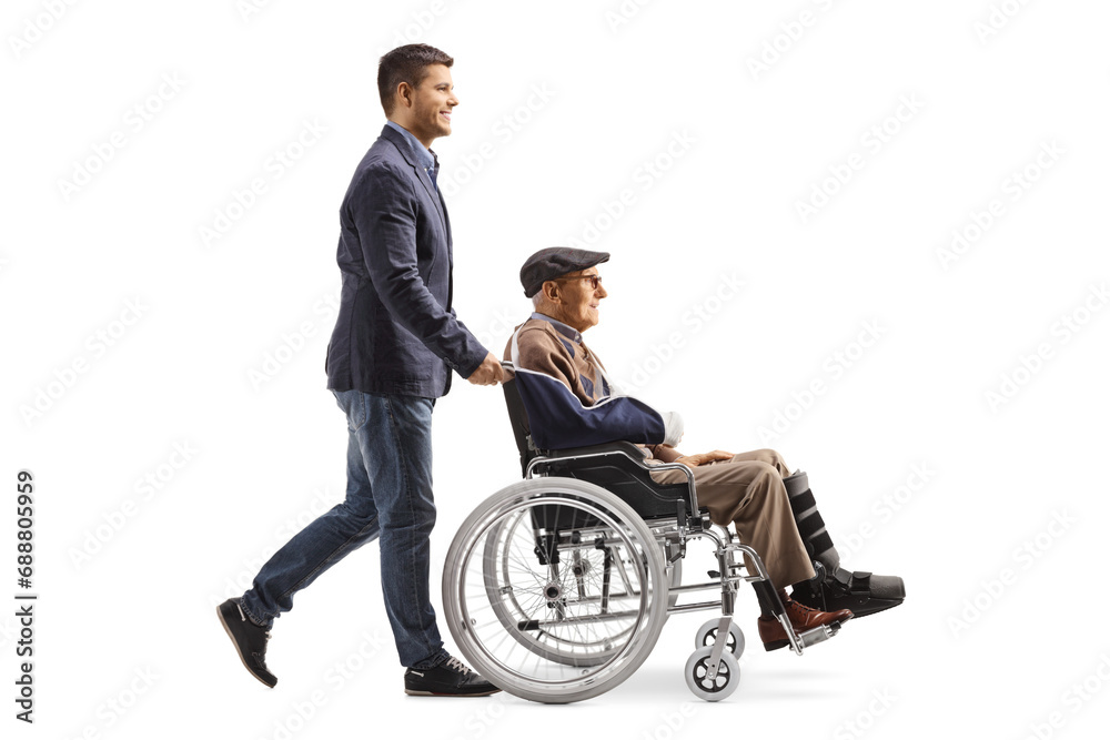 Son pushing injured father in a wheelchair Son pushing injured father in a wheelchair