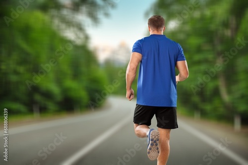 Cheerful and successful man jogging outdoor