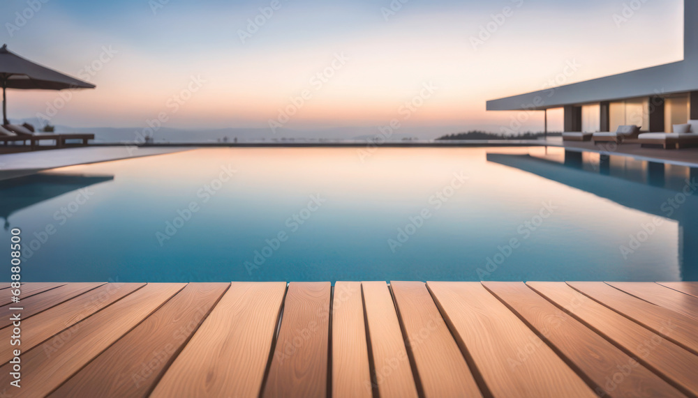 Obraz premium Empty wood table with resort pool behind with copy space