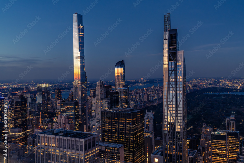 Aerial city skyline at night with last sun reflections
