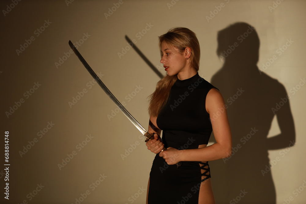 Beautiful woman with katana sword and her shadow Beautiful woman with katana sword and her shadow