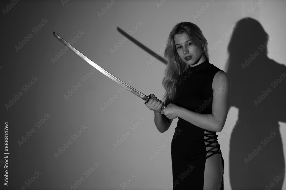 Young lady with katana sword in black and white