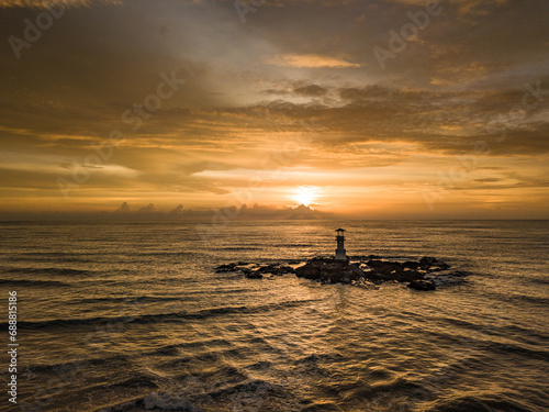 sunset on the beach with lighthouse