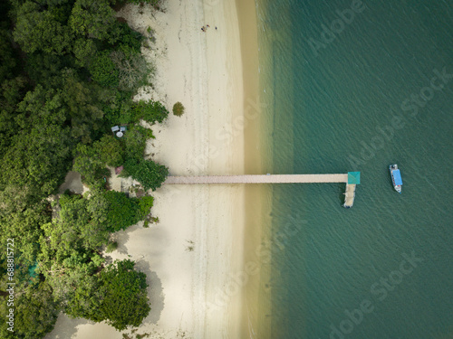 Drone picture of a boat at a jetty along the beach in Malaysia photo