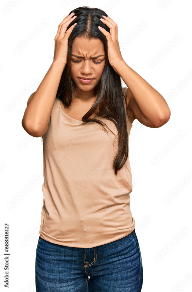 Beautiful hispanic woman wearing casual clothes suffering from headache desperate and stressed because pain and migraine. hands on head. Beautiful hispanic woman wearing casual clothes suffering from headache desperate and stressed because pain and migraine. hands on head.