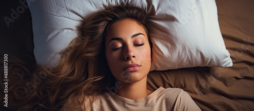 Sleep issues and overwhelmed woman with pillow on face, fatigued and frustrated, experiencing distressing sleep situations.
