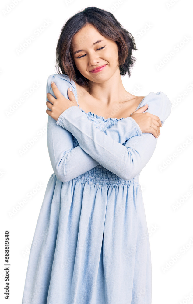 Young beautiful girl wearing casual clothes hugging oneself happy and positive, smiling confident. self love and self care Young beautiful girl wearing casual clothes hugging oneself happy and positive, smiling confident. self love and self care
