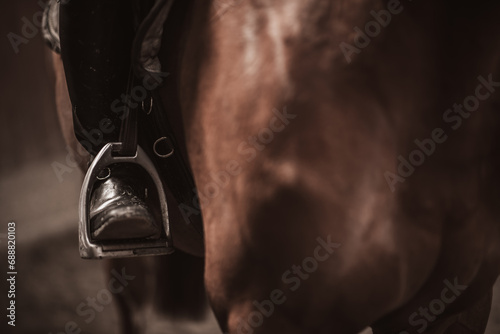 Close-up of the rider's leg. Horse jumping sport theme. photo