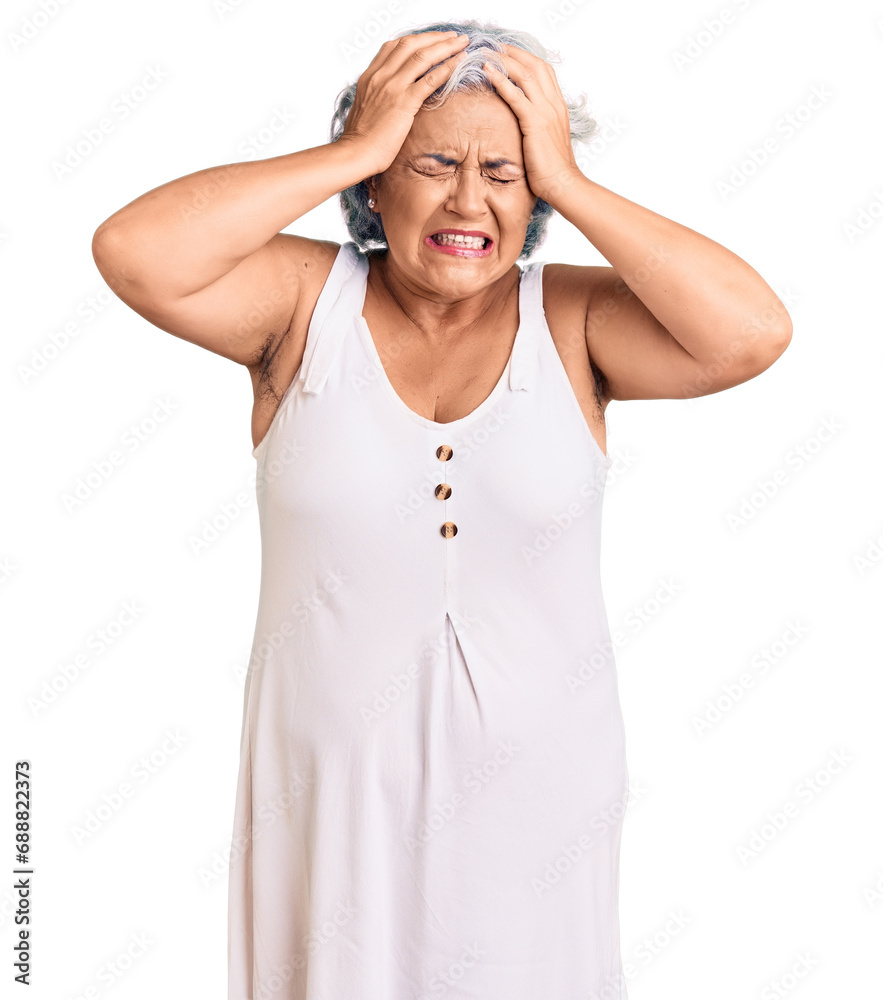 Senior woman with gray hair wearing casual clothes suffering from headache desperate and stressed because pain and migraine. hands on head. Senior woman with gray hair wearing casual clothes suffering from headache desperate and stressed because pain and migraine. hands on head.