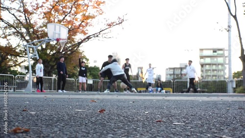 Wallpaper Mural TOKYO, JAPAN : View of unidentified young people playing BASKETBALL in the park. Shot in sunset time. Sports, fitness, exercise and health concept video. Slow motion shot. Torontodigital.ca