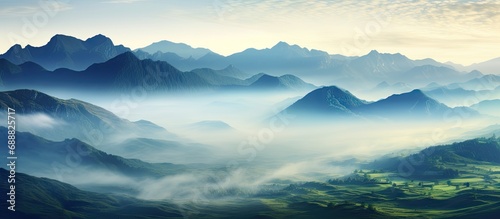 Foggy, rainy mountain landscape with cloudy mountain tops, spring dawn. © AkuAku