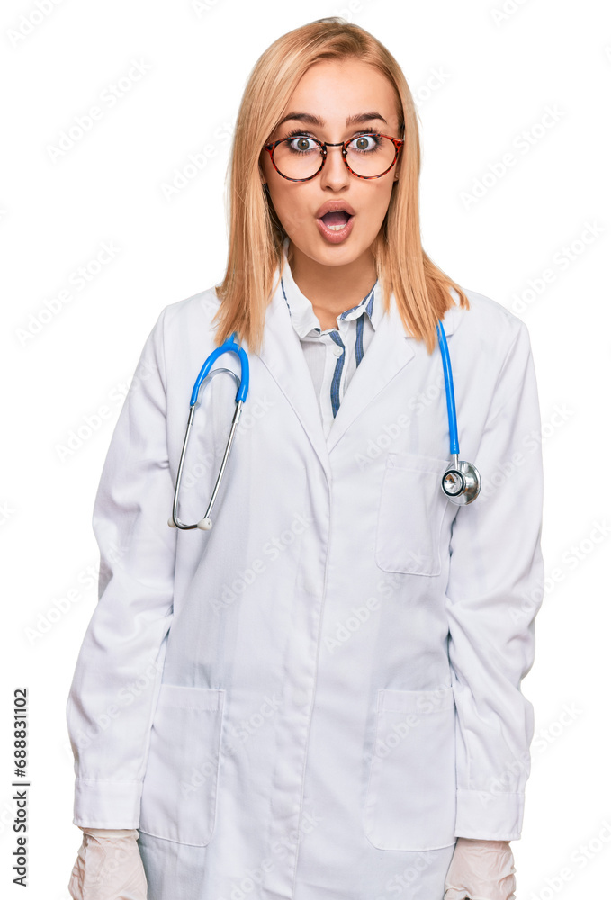 Beautiful caucasian woman wearing doctor uniform and stethoscope afraid and shocked with surprise expression, fear and excited face. Beautiful caucasian woman wearing doctor uniform and stethoscope afraid and shocked with surprise expression, fear and excited face.