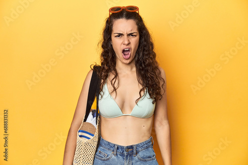 Woman in summer look, bikini, beach essentials, screaming very angry and aggressive.