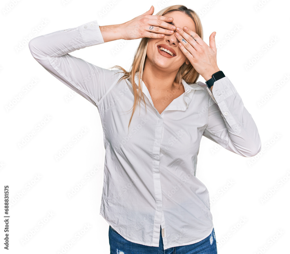 Young caucasian woman wearing casual clothes covering eyes with hands smiling cheerful and funny. blind concept. Young caucasian woman wearing casual clothes covering eyes with hands smiling cheerful and funny. blind concept.