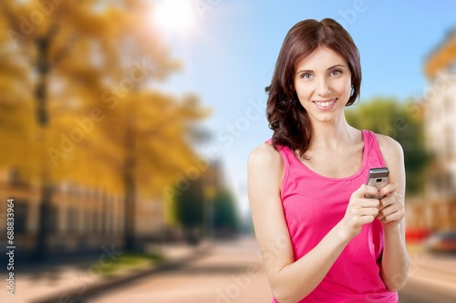 Fototapeta Naklejka Na Ścianę i Meble -  Happy woman hold mobile phone
