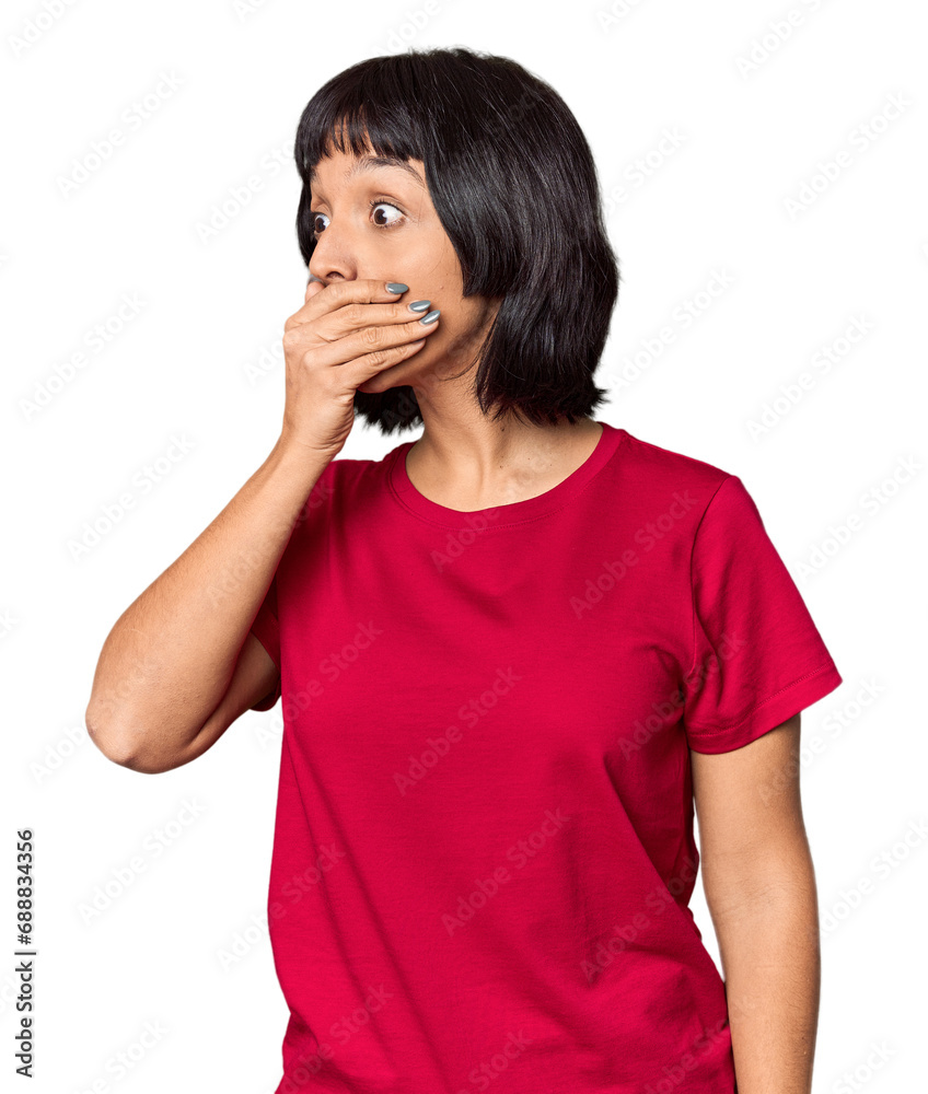 Young Hispanic woman with short black hair in studio thoughtful looking to a copy space covering mouth with hand.