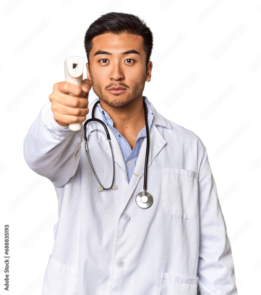 Chinese male doctor holding a temperature meter in studio Chinese male doctor holding a temperature meter in studio