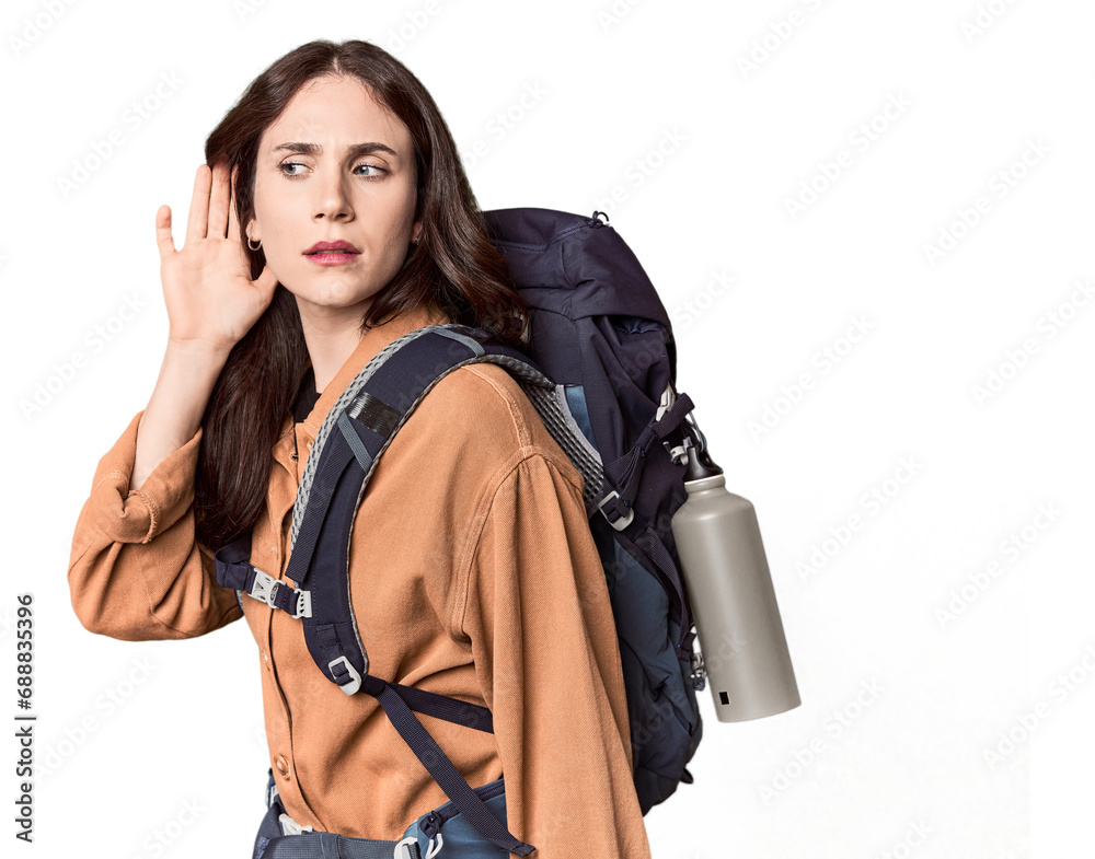 Young Caucasian with hiking gear and bottle trying to listening a gossip. Young Caucasian with hiking gear and bottle trying to listening a gossip.