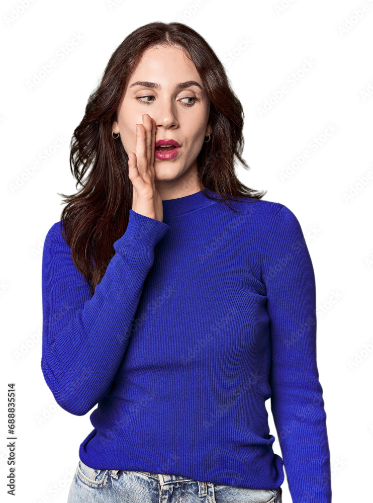 Young Caucasian woman in a studio setting being shocked because of something she has seen.
