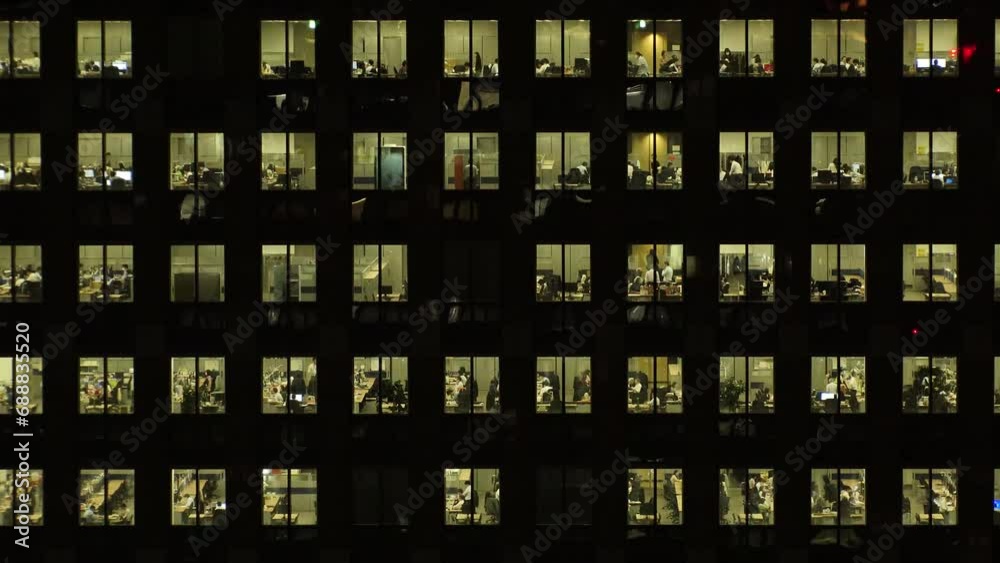 TOKYO, JAPAN : Close up shot of exterior of office building window at night. Company, corporate, job, work and business people concept video. Time lapse shot. 