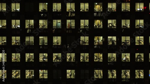 TOKYO, JAPAN : Close up shot of exterior of office building window at night. Company, corporate, job, work and business people concept video. Time lapse shot. 