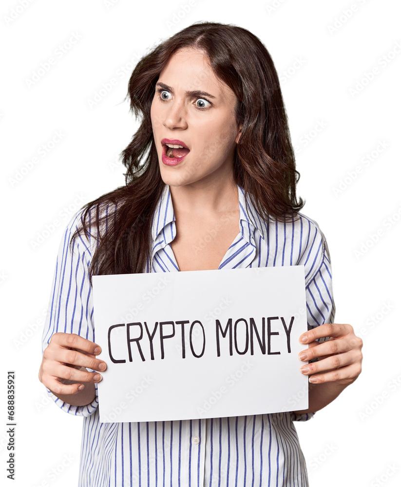Young Caucasian woman with 'cryptomoney' banner in studio Young Caucasian woman with 'cryptomoney' banner in studio