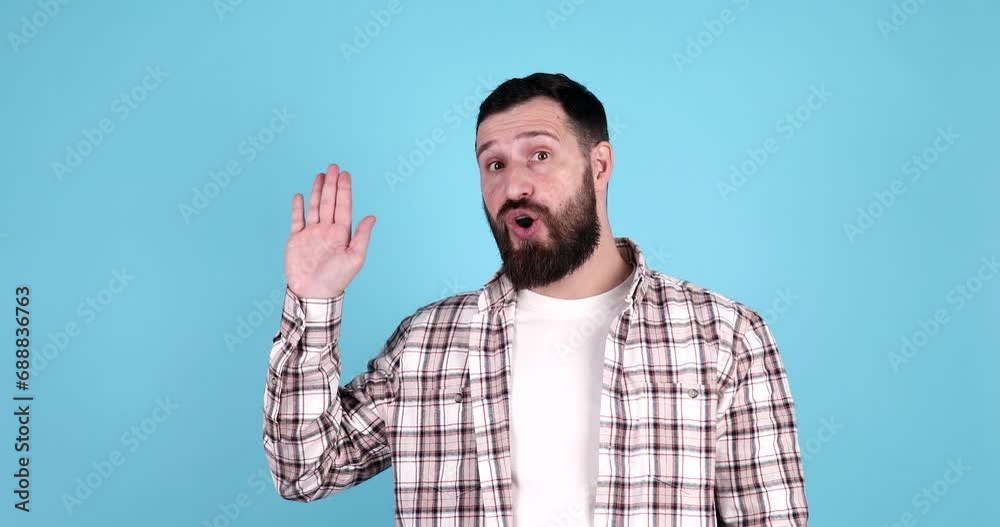 Young handsome bearded man wearing casual waiving saying hello happy and smiling, friendly welcome gesture on blue background. Young handsome bearded man wearing casual waiving saying hello happy and smiling, friendly welcome gesture on blue background.