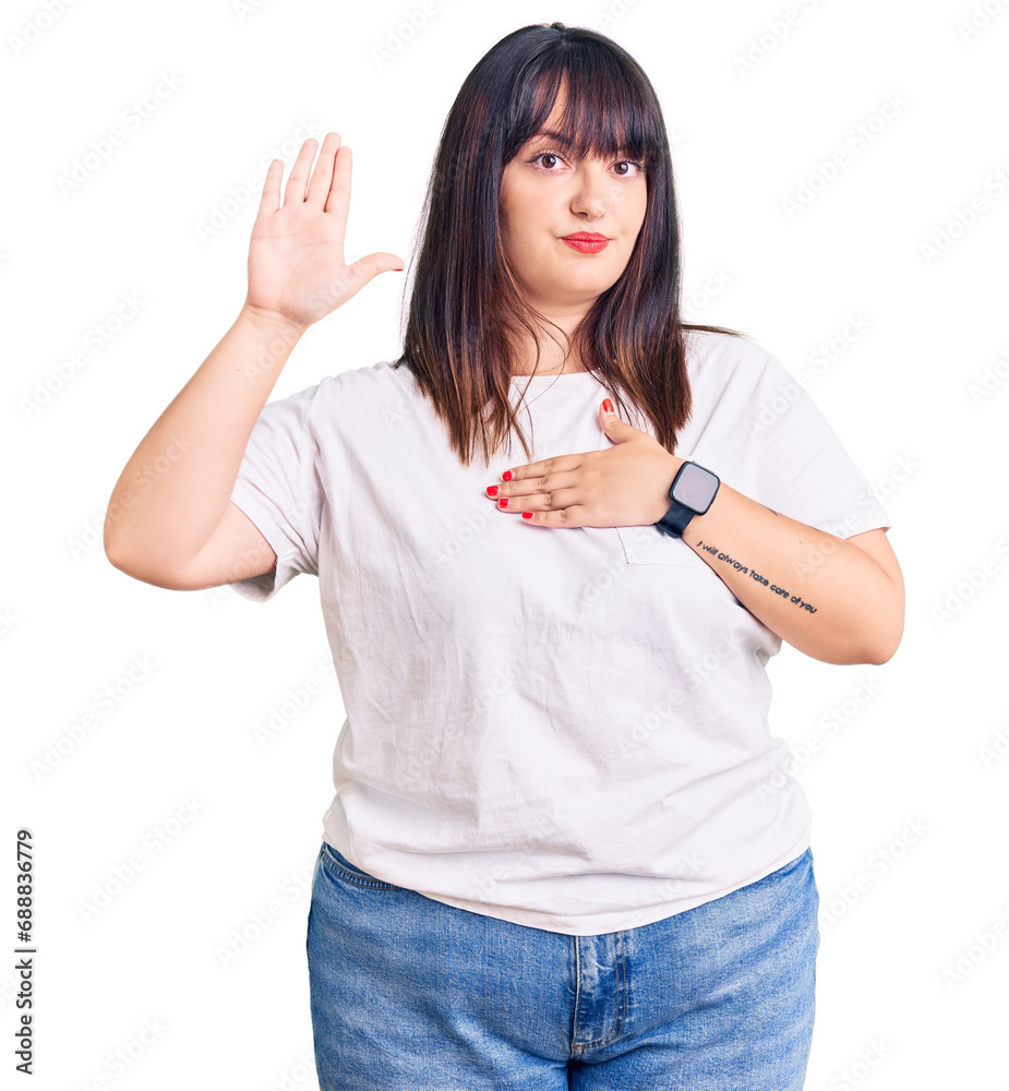 Young plus size woman wearing casual clothes swearing with hand on chest and open palm, making a loyalty promise oath Young plus size woman wearing casual clothes swearing with hand on chest and open palm, making a loyalty promise oath