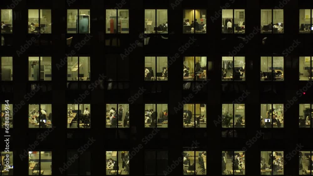 TOKYO, JAPAN : Close up shot of exterior of office building window at night. Company, corporate, job, work and business people concept video. Time lapse shot. 