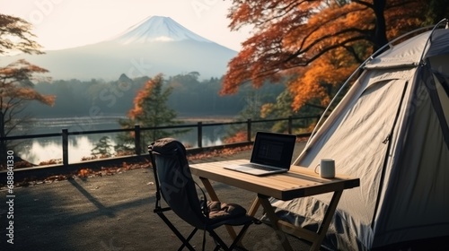 outdoor office near camping tent at Mount Fuji of businessman while traveling on holiday.