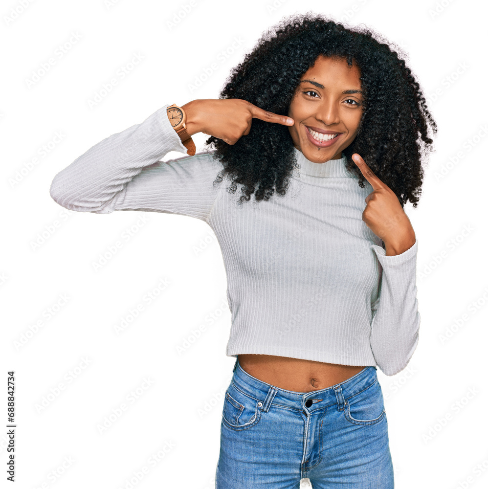 Young african american girl wearing casual clothes smiling cheerful showing and pointing with fingers teeth and mouth. dental health concept. Young african american girl wearing casual clothes smiling cheerful showing and pointing with fingers teeth and mouth. dental health concept.
