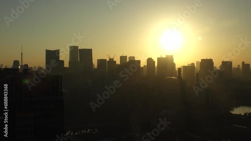 TOKYO, JAPAN - NOV 2023 : Aerial high angle view of cityscape of Tokyo and Mount Fuji in sunset. View of office buildings around Tokyo station and Nagatacho area. 4K time lapse shot, day to night. photo