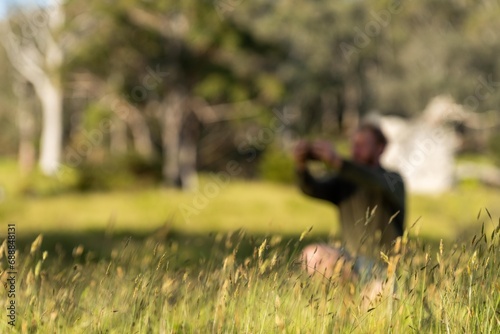 farmer holding pasture and grasses on a regenerative farm. native plants storaging carbon.