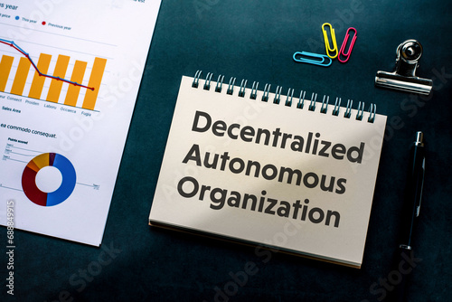There is notebook with the word Decentralized Autonomous Organization. It is as an eye-catching image.