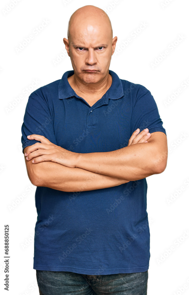 Middle age bald man wearing casual clothes skeptic and nervous, disapproving expression on face with crossed arms. negative person. Middle age bald man wearing casual clothes skeptic and nervous, disapproving expression on face with crossed arms. negative person.