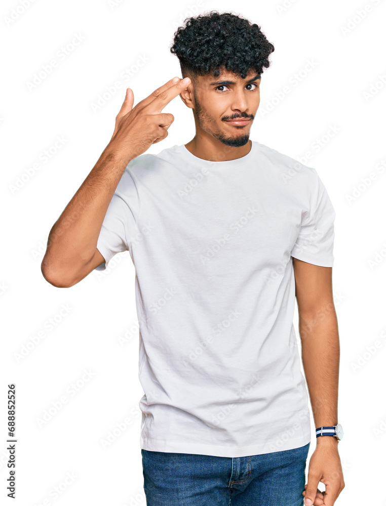 Young arab man wearing casual white t shirt shooting and killing oneself pointing hand and fingers to head like gun, suicide gesture. Young arab man wearing casual white t shirt shooting and killing oneself pointing hand and fingers to head like gun, suicide gesture.