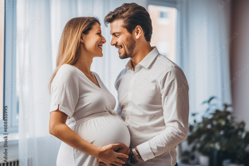 Man and woman smiling and being happy because they found out they will get a baby at doctors office at examination. Pregnancy, hugging. Man and woman smiling and being happy because they found out they will get a baby at doctors office at examination. Pregnancy, hugging.