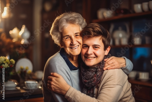 Teenage grandson hugs his old grandmother at home. blurred background. Caring grandparent comforting teenage grandson. photo