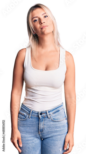 Young beautiful blonde woman wearing casual sleeveless t-shirt relaxed with serious expression on face. simple and natural looking at the camera.