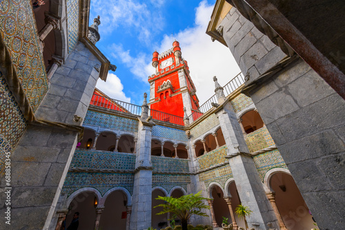 Interior courtyard with the bright red main clock tower in view inside Pena Palace, in the mountains of Sintra, near Lisbon Portugal. photo