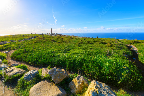 Visitors at Cabo da Roca, or Cape Roca, enjoy the Atlantic ocean views and the Cabo Da Roca monument at the westernmost point of mainland Europe in Colares, Portugal, near Sintra and Lisbon. photo