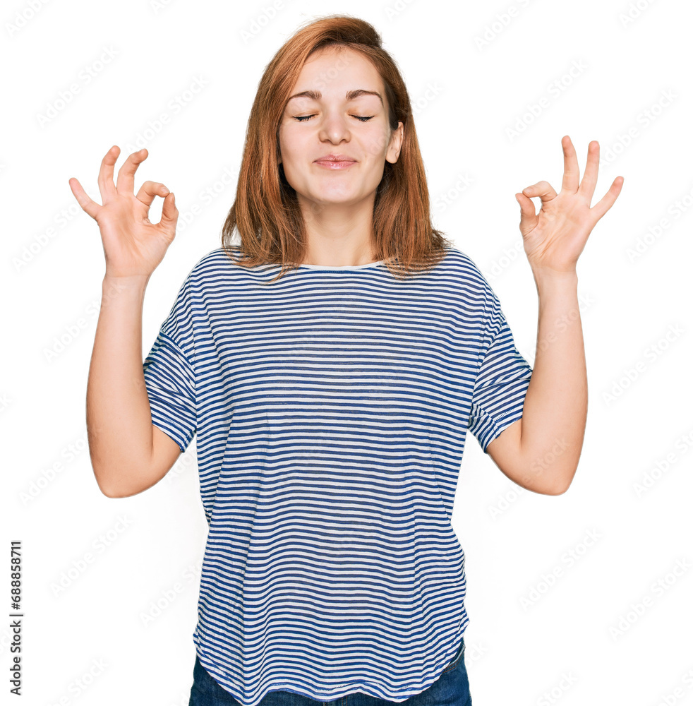 Young caucasian woman wearing casual clothes relax and smiling with eyes closed doing meditation gesture with fingers. yoga concept. Young caucasian woman wearing casual clothes relax and smiling with eyes closed doing meditation gesture with fingers. yoga concept.