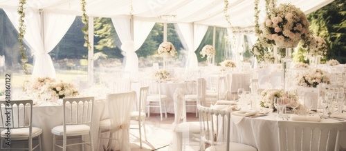Summer wedding decor featuring floral centerpieces in white.