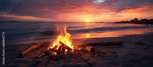 Beach bonfire with stunning sunset or sunrise, and no one else around. photo