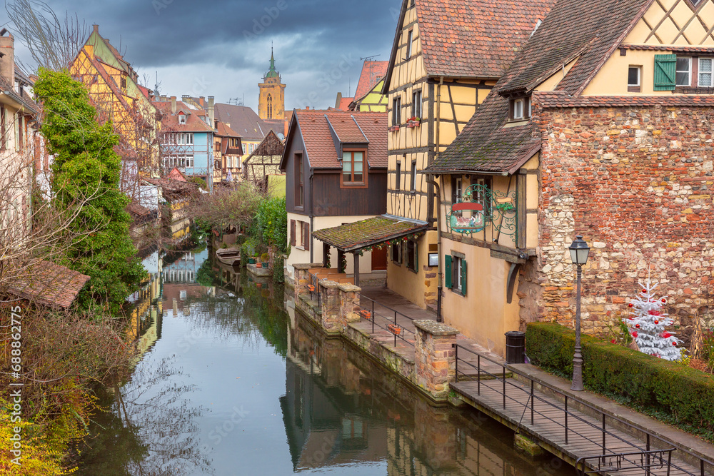 Fototapeta premium Traditional Alsatian half-timbered houses, church and river Lauch, Colmar, Alsace, France